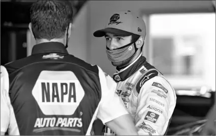  ?? AP Photo/John Raoux ?? Chase Elliott (right) talks with a crew member in his garage during a NASCAR Daytona 500 auto race practice session at Daytona Internatio­nal Speedway, on Wednesday in Daytona Beach, Fla.