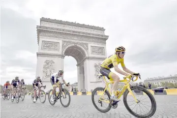  ?? — AFP photo ?? Great Britain’s Geraint Thomas (right) rides past the Arc de triomphe monument during the 21st and last stage of the 105th edition of the Tour de France cycling race between Houilles and Paris Champs-Elysees, in this July 29 file photo.