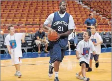  ?? DANA JENSEN/THE DAY ?? Stanley Robinson plays with the ball boys before the Jim Calhoun Celebrity Classic Charity All-Star Game in 2010 at Mohegan Sun Arena. Robinson, 32, died on Tuesday in Birmingham, Ala.