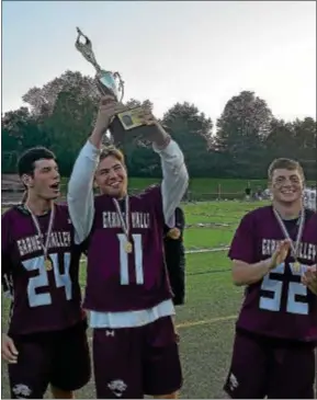  ?? PETE BANNAN — DIGITAL FIRST MEDIA ?? Garnet Valley goaltender Jason Rose, center, joins fellow captains Jon Ricci, left, and Austin Patton in lifting the District 1 Class 3A trophy. Rose made 15 saves in the final to lead the Jaguars to a 5-4 win over Conestoga, part of a dazzling...