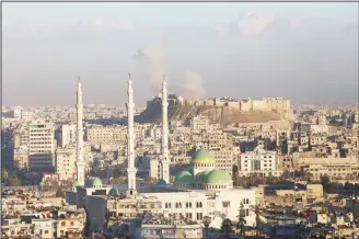  ??  ?? A general view taken from the government-held side of Aleppo shows smoke billowing near Aleppo’s historic citadel during fighting between regime forces and rebel fighters on Dec 3. Syria’s army advanced deeper into east Aleppo where by Nov 3 it...