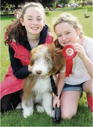  ??  ?? Winner Best Four-month-old bearded collie Angus too first prize in the best puppy category with owners Olivia Donachie, 11, and sister Emily,8