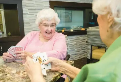  ?? SMITH CROSSING ?? Lorraine Kane, 101, loves to play cards with her friends at the Smith Crossing senior living complex in Orland Park and says that the companions­hip there helps keep her brain sharp.