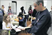  ?? Nikolas Samuels/The Signal ?? From left to right, Sophia Levine, 8, shows her dad, Daniel Levine, prints she made during Flutterby Art Studio at ARTree Community Arts Center in January.