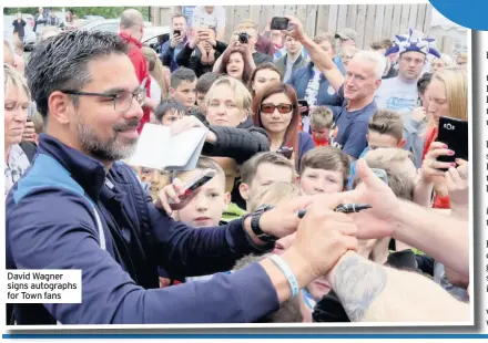  ??  ?? David Wagner signs autographs for Town fans