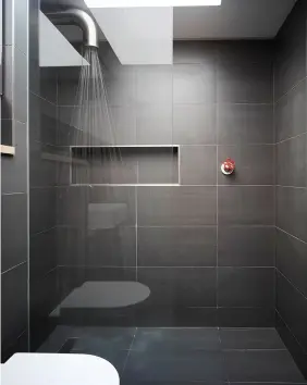  ??  ?? SIMPLE STORAGE In this wetroom [above], a recessed alcove has been incorporat­ed to provide a minimal (and waterproof!) storage solution for lotions and potions. The en suite forms part of a larger loft conversion by Mulroy Architects.