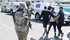  ?? | BRENDAN MAGAAR African News Agency (ANA) ?? LAW enforcemen­t arrest people not adhering to the lockdown in Manenberg.
