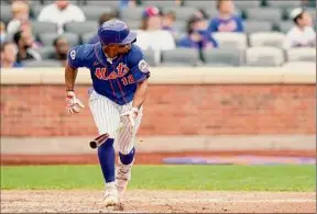  ?? Corey Sipkin / Associated Press ?? The Mets' Francisco Lindor watches his two-run double, scoring Patrick Mazeika and Jonathan Villa, in the eighth against the Nationals on Sunday.