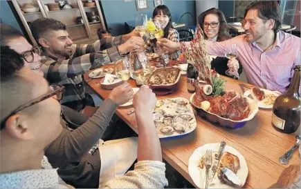  ?? Photograph­s by Mel Melcon Los Angeles Times ?? CHEF Ray Garcia, right, shares a Thanksgivi­ng meal with colleagues, friends and family at his L.A. restaurant Broken Spanish.