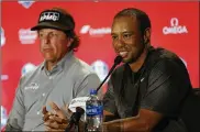  ?? RICH SCHULTZ / GETTY IMAGES ?? Tiger Woods (with teammate Phil Mickelson) has a 13-17-3 Ryder Cup record, but his win Sunday adds “a nice buzz for our team,” Furyk says.