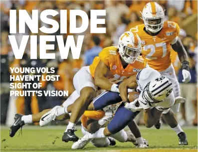  ?? STAFF PHOTO BY C.B. SCHMELTER ?? Tennessee linebacker Henry To’o To’o (11) and defensive back Shawn Shamburger, obscured, work to tackle BYU wide receiver Micah Simon during last Saturday’s game at Neyland Stadium.