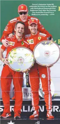  ?? AFPPIX ?? Ferrari’s Sebastian Vettel (R) celebrates his victory on the podium with third-placed teammate Kimi Raikkonen (top) after the Formula One Australian Grand Prix in Melbourne yesterday. –