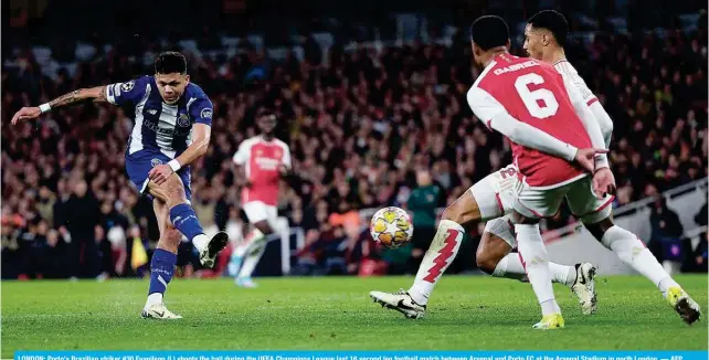  ?? — AFP ?? LONDON: Porto’s Brazilian striker #30 Evanilson (L) shoots the ball during the UEFA Champions League last 16 second leg football match between Arsenal and Porto FC at the Arsenal Stadium in north London.