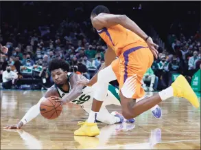  ?? Mary Schwalm / Associated Press ?? Celtics guard Marcus Smart, left, dives for a loose ball ahead of Suns forward Mikal Bridges on Friday.