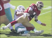  ?? JED JACOBSOHN — THE ASSOCIATED PRESS ?? Dolphins defensive end Zach Sieler, left, sacks 49ers quarterbac­k Jimmy Garoppolo during the first half on Sunday in Santa Clara.