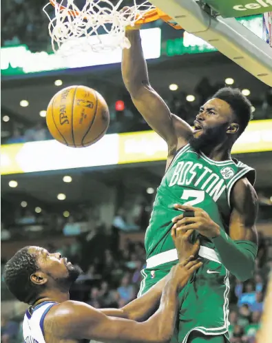  ?? Michael Dwyer / Associated Press ?? Cal alum Jaylen Brown dunks over the Warriors’ Kevin Durant. Brown scored 22 points, Durant 24.