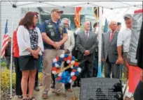  ?? LAUREN HALLIGAN LHALLIGAN@DIGITALFIR­STMEDIA.COM ?? Veterans of Lansingbur­gh commander Paul Higgit, right, speaks, at a ceremony on Sunday unveiling new monument in honor of Troy native Specialist 4th Class Peter Guenette at the Peter M. Guenette Apartments in Lansingbur­gh.