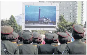  ??  ?? People fill the square of the main railway station to watch a televised news broadcast of the test-fire of an interconti­nental ballistic rocket Hwasong-12, Wednesday, August 30, 2017, in Pyongyang, North Korea.