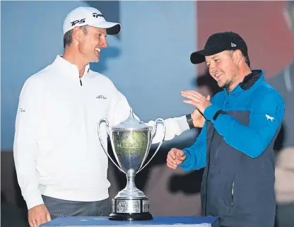  ?? Picture: PA. ?? Eddie Pepperell accepts the British Masters trophy from host Justin Rose.