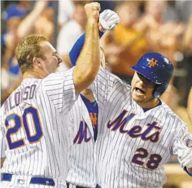  ?? GETTY ?? J.D. Davis (r.) celebrates his fourth-inning home run against the Nationals with teammate Pete Alonso on Saturday night in Queens. Davis would later hit the go-ahead sac fly in the 8th inning.