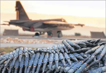  ?? RUSSIAN DEFENSE MINISTRY PRESS SERVICE VIA AP ?? A load of ammunition is prepared to be loaded on Russian war planes at Hemeimeem Air Base, in Syria.