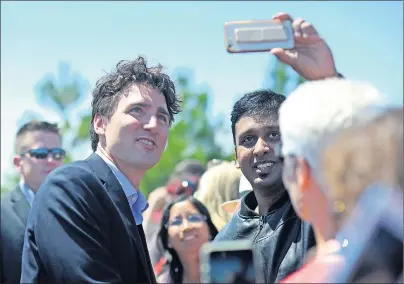  ?? NATHAN ROCHFORD/THE GUARDIAN ?? Prime Minister Justin Trudeau greets people on the Charlottet­own waterfront on Thursday.