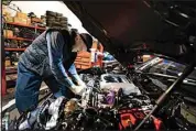  ?? MATT ROURKE / AP ?? Mechanic David Stoliaruk works on the engine of a car at IC Auto in Philadelph­ia May 2.