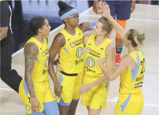  ?? MIKE CARLSON/AP ?? Allie Quigley (second from right) became the Sky’s all-time leading scorer after scoring 23 points in a loss Wednesday against the Lynx.