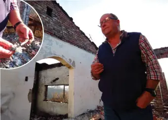  ?? Photos: Stefan Goosen ?? Heinz Kramer stands among the ruins of his home in Templeman Drive, Knysna Heights. INSERT: Kramer holds in his left hand (on the right) what remains of a pocket knife, a gift from his wife, which he hoped might have survived the inferno that destroyed...