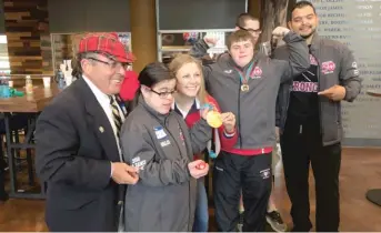  ?? MADELINE KENNEY/ SUN- TIMES PHOTOS ?? Olympic gold medalist Kendall Coyne poses with a group of athletes who are going to represent Chicago at the Special Olympics USA Games in Seattle this summer.