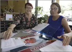  ??  ?? Pasco County Commission candidates Kelly Smith (left) and Brandi Geoit prepare forms for their Galentine’s Day meeting Monday in Lutz, Fla. Galentine’s Day, which is celebrated on Feb. 13, is a day to celebrate not only women’s friendship­s, but...