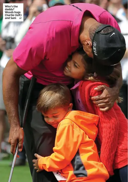  ?? AP ?? Who’s the daddy? Woods hugs Charlie (left) and Sam