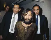  ?? AP 1969 ?? Charles Manson, who died Sunday at 83, is escorted in 1969 to his arraignmen­t on charges in the Sharon
Tate murder case. The charismati­c, gurulike Manson surrounded himself in the 1960s with runaways and other lost souls, then sent his disciples to...