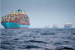  ?? ERIN SCHAFF/THE NEW YORK TIMES ?? Container ships wait to enter the Port of Los Angeles on Oct. 17. Surging inflation and supply chain disruption­s are disrupting global economic recovery.