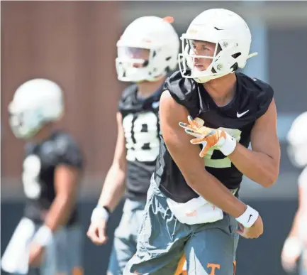  ?? CAITIE MCMEKIN/NEWS SENTINEL ?? Tennessee quarterbac­k J.T. Shrout (12) throws the ball during a drill at the Vols’ practice on University of Tennessee’s campus on Aug. 3.