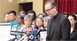  ?? COLIN BOYLE/ SUN- TIMES ?? The Rev. Brendan A. Curran speaks Thursday at St. Peter’s Catholic Church in Chicago. He was among the faith leaders gathered to denounce what they called the “inhumane” family separation policy at the U. S.- Mexico border.