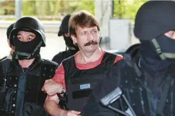  ?? APICHART WEERAWONG/AP ?? Russian arms dealer Viktor Bout is led by Thai police into criminal court in Bangkok in 2010 prior to his extraditio­n to the U.S. Now Bout is back in the headlines with speculatio­n about being part of a U.S.-Russia prisoner exchange.