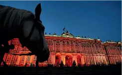 ?? PHOTO: REUTERS ?? A horse stands at Dvortsovay­a Square in front of the State Hermitage Museum illuminate­d for the 100th anniversar­y of the Red October revolution, in St Petersburg, Russia.