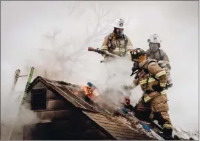  ?? SUBMITTED PHOTO ?? Firefighte­rs stand on the roof of a burning structure at Emergency Nexus.