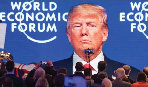  ??  ?? Address: Donald Trump’s speech at the World Economic Forum in Davos yesterday is shown on a large screen