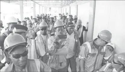  ??  ?? Workers paying keen attention to an address in April during a visit by Minister of Natural Resources, Raphael Trotman.