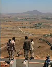  ?? (Alaa Al-Faqir/Reuters) ?? FREE SYRIAN ARMY fighters stand together yesterday in the Quneitra countrysid­e in Syria.