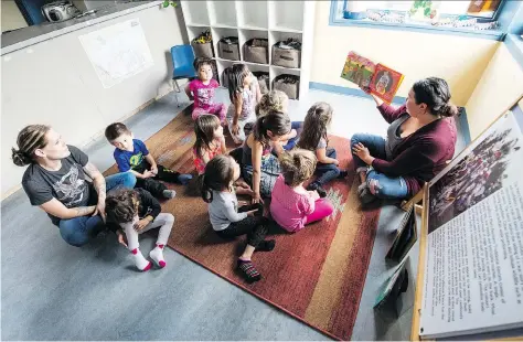  ?? BRANDON HARDER ?? Larissa Anderson, right, director of children’s services for The Circle Project’s Children’s Centre, reads to children at the facility on Pasqua Street, where kids learn about aspects of their Indigenous heritage such as language, traditions, powwows...