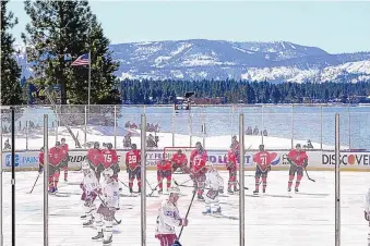  ?? RICH PEDRONCELL­I/ASSOCIATED PRESS ?? Members of the Colorado Avalanche, in white, and Vegas Knights warm up before their game Saturday in Stateline, Nevada. The game was interrupte­d after the first period because of ice issues.