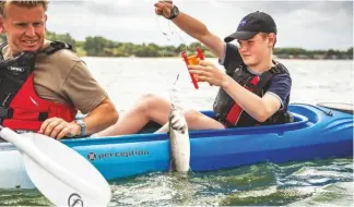  ??  ?? William catches a school bass trolling with a handline in the estuary, but this one is too small to keep