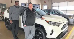  ?? USA TODAY ?? Deuntae Carr, left, and Eric Miller show off the 2021 Toyota RAV4.