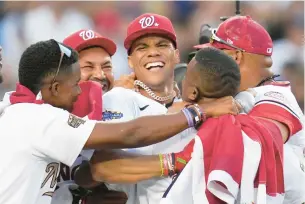  ?? KEITH BIRMINGHAM/PASADENA STAR-NEWS ?? Washington Nationals outfielder Juan Soto, center, is congratula­ted after winning the All-Star Home Run Derby on Monday night at Dodger Stadium.