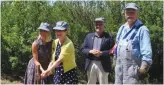  ??  ?? (l-r) Maeghan Dubois and Nancy Martin drive in the last spike along with MLA Michelson and Tim Pomeroy (WDM Chief Engineer and Restoratio­n manager)