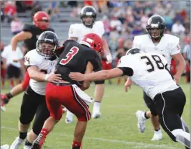  ??  ?? LaFayette senior twins Grayson (left) and Grant Blaschke team up to put a hit on LFO quarterbac­k Noah Flowers during last Tuesday's scrimmage in Fort Oglethorpe. (Messenger photo/Scott Herpst)