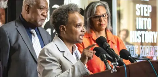  ?? ASHLEE REZIN/SUN-TIMES ?? U.S. Reps. Danny Davis and Robin Kelly listen as Mayor Lori Lightfoot speaks during a news conference Thursday morning at the DuSable Black History Museum and Education Center.